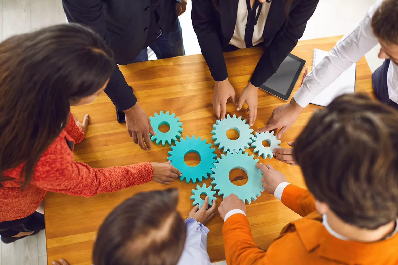 Team arranging gears to symbolize centralized data