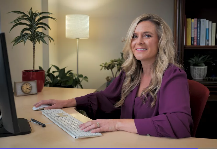 woman sitting at desk using nonprofit membership management software