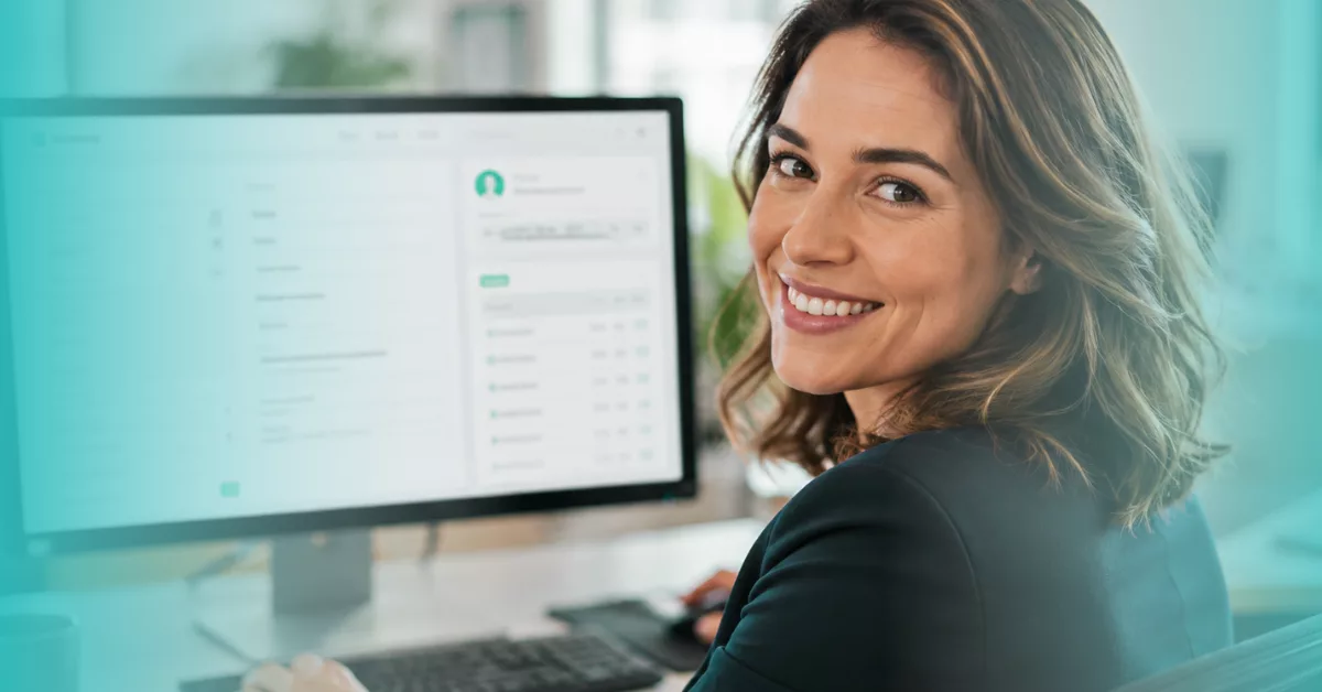 Female professional glancing back from her screen